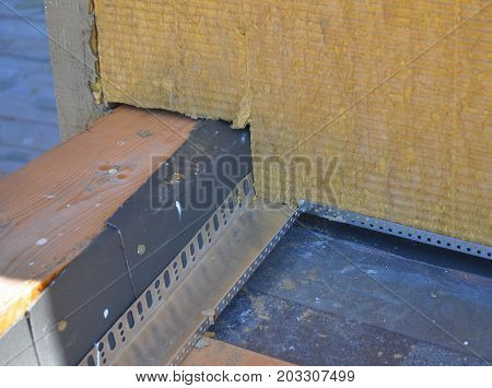 Closeup on Roof Corner Insulation and Waterproofing. Insulating Between and Under Roof Joists. Thermal Bridges Insulation