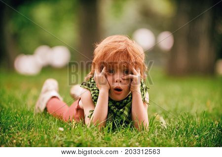 Red head boy playing in the park