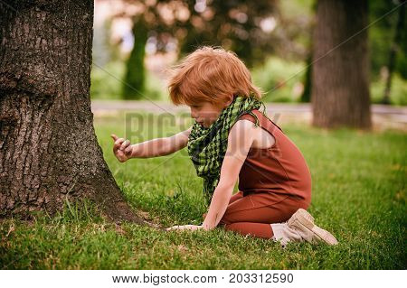 Red head boy playing in the park