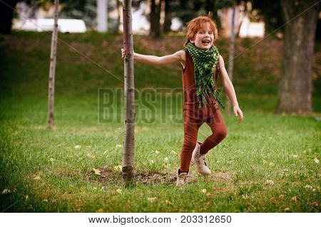 Red head boy playing in the park
