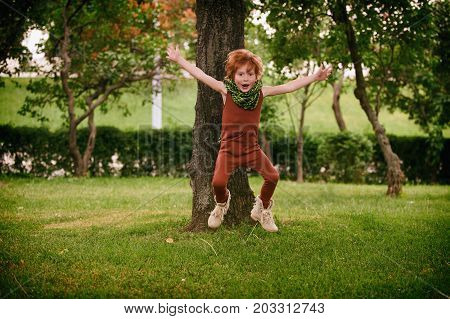 Red head boy playing in the park
