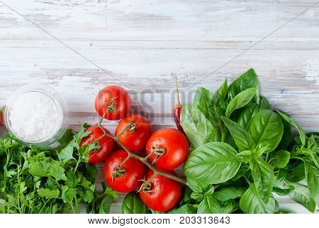 Tomatoes And Bunch Of Fresh Green Basil On A  Wood Background,