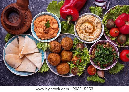 Selection of Middle eastern or Arabic dishes. Falafel, hummus, pita and  muhammara. Top view