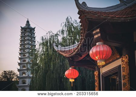 Vietnamese buddhist temple. Red lanterns and pagoda