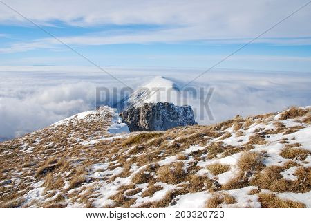 Mountain peak above the clouds. Sunny winter day on mountain above the clouds. Dry mountain in Serbia in winter with highest peak Trem