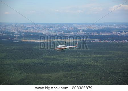 A Large Helicopter Is Flying In The Blue Sky.