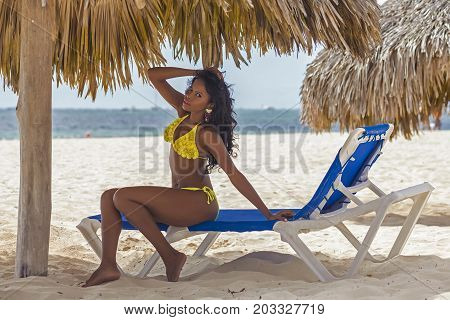 sexy black girl is relaxing on the beach