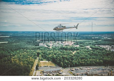 A Large Helicopter Is Flying In The Blue Sky.
