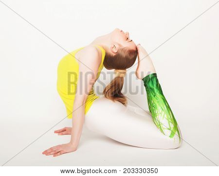 lifestyle, sport  and people concept: young woman in yoga pose sitting on a floo