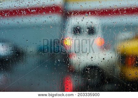 Drops on a car glass with blurred city background