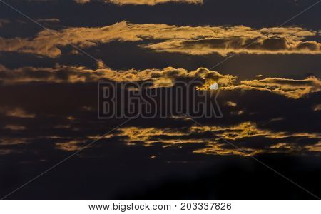 Full Moonrise among beautiful vlouds at suumer night