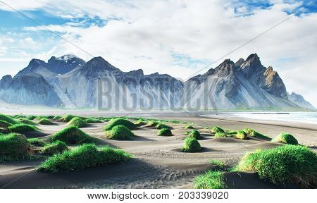 Fantastic west of the mountains and volcanic lava sand dunes on the beach Stokksness, Iceland