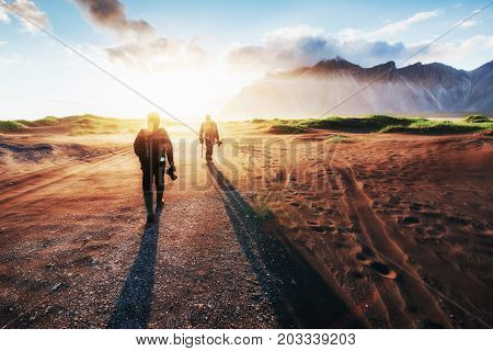 Fantastic west of the mountains and volcanic lava sand dunes to the beach Stokksness. Tourists traveling through the wilderness. Iceland