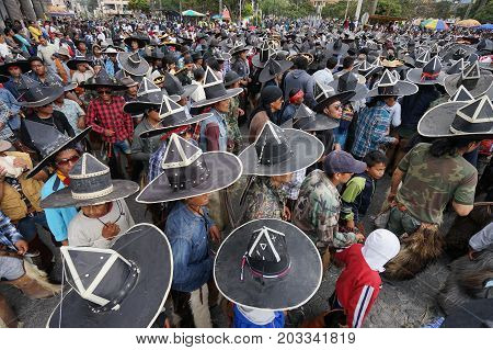 June 29 2017 Cotacachi Ecuador: indigenous men wearing extra large sombreros dancing in the main square of the town at Inti Raymi
