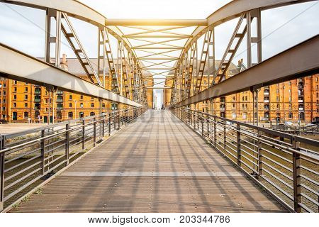 View on the old iron bridge and red brick warehouses in Hafen district of Hamburg city in Germany