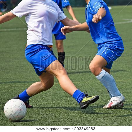 Women are playing soccer outdoor in summer