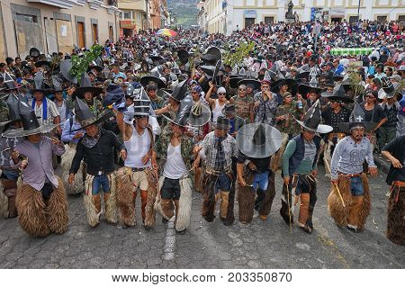 June 29 2017 Cotacachi Ecuador: indigenous Kichwa crowd dancing on the street celebrating Inti Raymi