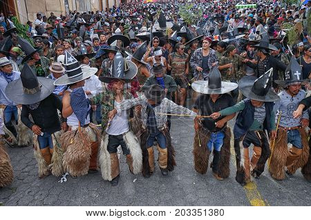 June 29 2017 Cotacachi Ecuador: indigenous Kichwa crowd dancing on the street celebrating Inti Raymi