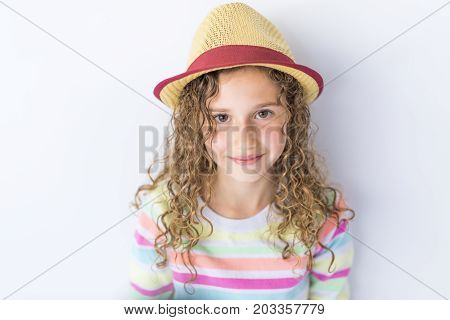 A Portrait of 9 years old girl with curly hair, isolated on gray