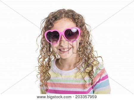 A Portrait of happy, smiling, confident 9 years old girl with curly hair, isolated on white