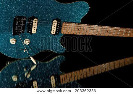 Glam rock guitar. Electric guitar with vibrant blue glitter finish. Fun party band musical instrument with funky look.