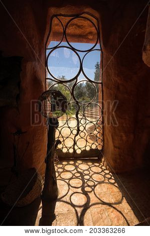 July 21 2017 Villa de Leyva: wrought iron artisan door of the conceptual eco-house 'Casa de Terracota' open and allowing full access for paying visitors