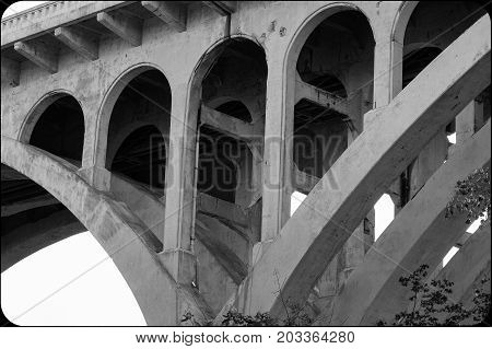 Cement understructure of a bridge in black and white.