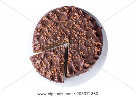 Isolated Chocolate Layered Cake With Nougat And Sponge Cake In The Cut On The Plate, Top View