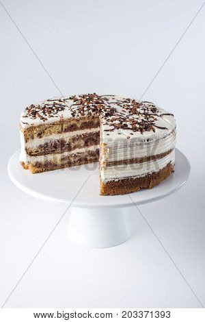 Isolated Beautiful Homemade Layered Sponge Cake With White Cream In Rustic Style With The Cut Out Pi
