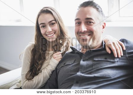 A nice and cool Teenager girl sitting on window with father