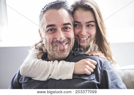 A nice and cool Teenager girl sitting on window with father