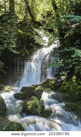 Waterfall in the sun near Rinnen in Montafon Austria.