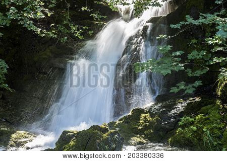 Waterfall in the sun near Rinnen in Montafon Austria.