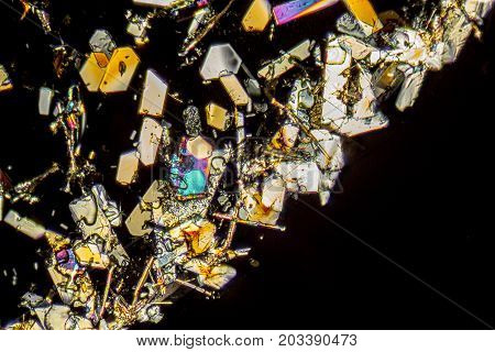 microscopic shot showing colorful microcrystals in polarised light
