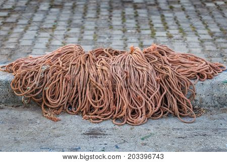A pile of rope on asphalt for fishermen's networks.