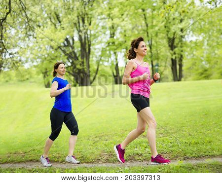 Two Beautiful Female runner outside having fun