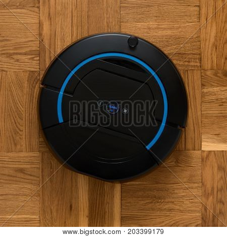 Top view of robotic vacuum cleaner cleaning floor. image with square aspect ratio