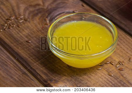 Sauce in a glass bowl on a background of a board