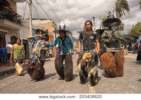 July 24 2017 Cotacachi Ecuador: indigenous kichwa men wearing a traditional chaps on the street at Inti Raymi celebration