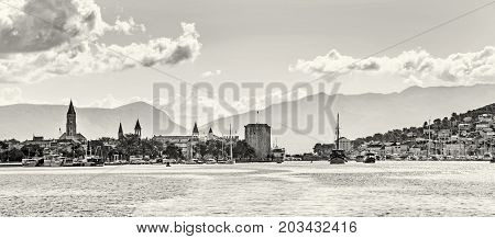 Panoramic photo of the old town Trogir and Ciovo island with harbor. Summer vacation. Travel destination. Black and white photo.