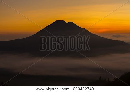 Scenic sunrise and mist at Batur volcano Kintamani Bali Indonesia. Sunrise view of Batur volcano Bali island Indonesia. Bali volcano. Bali nature landscape