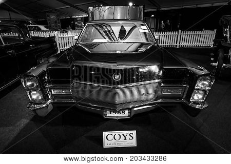 MAASTRICHT NETHERLANDS - JANUARY 08 2015: Full-size luxury car Cadillac series 75 Fleetwood 1968. Black and white. International Exhibition InterClassics & Topmobiel 2015
