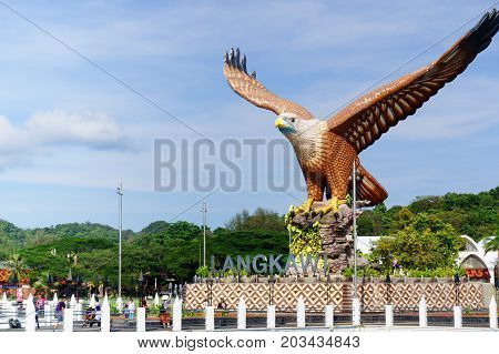 Langkawi, Malaysia - 3rd May 2017: Shot of Langkawi's famous landmark the Eagle square, Dataran Lang, from the sea in front of it. The blue cloudy sky and beautiful blue water show how Malaysia's beauty