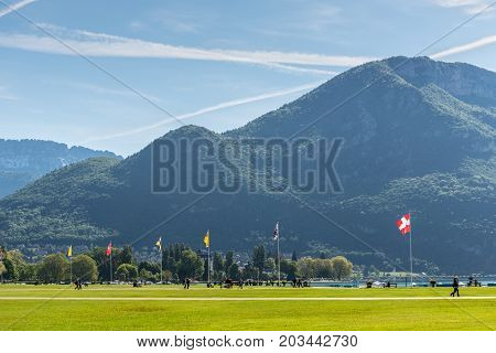 Annecy France - May 25 2016: A large open space surrounds the Annecy lake where people were enjoying the spring sunshine.