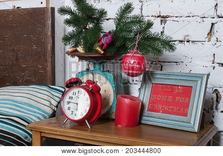 Vintage Retro Style Alarm Clock and new years decor on nightstand.