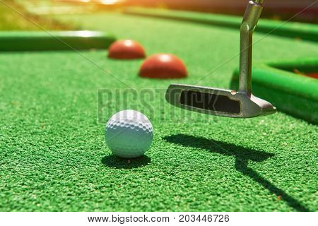Golf ball and Golf Club on Artificial Grass.