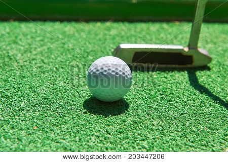 Mini-golf ball on artificial grass. Summer season game