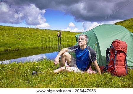Hiking in the mountains with a backpack in the summer.