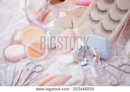 Cosmetic accessories mixed with hair salon equipment in cute candy color.