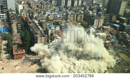 Downtown building demolition by controlled implosion in China